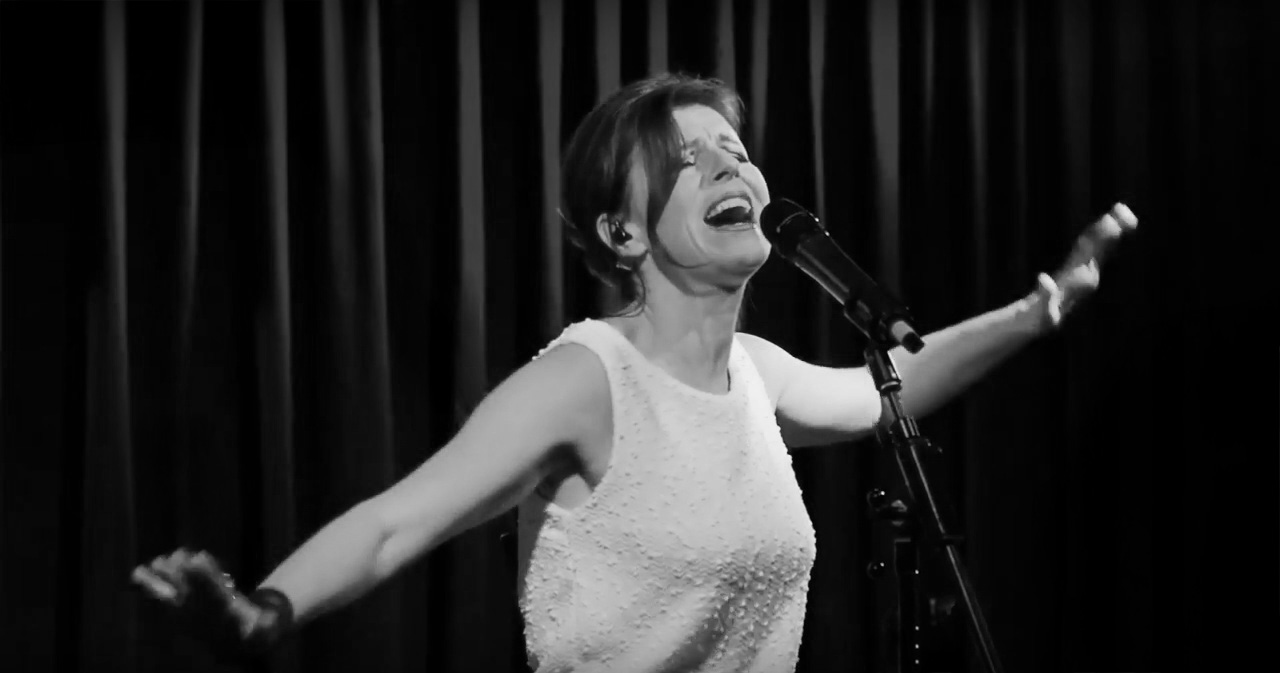 Anna Tendera on stage, black and white